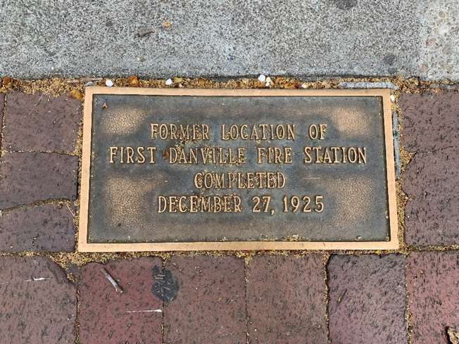Small plaque in the sidewalk